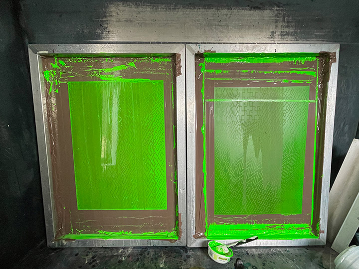 Washout booth, with two screens in, covered in bright green ink