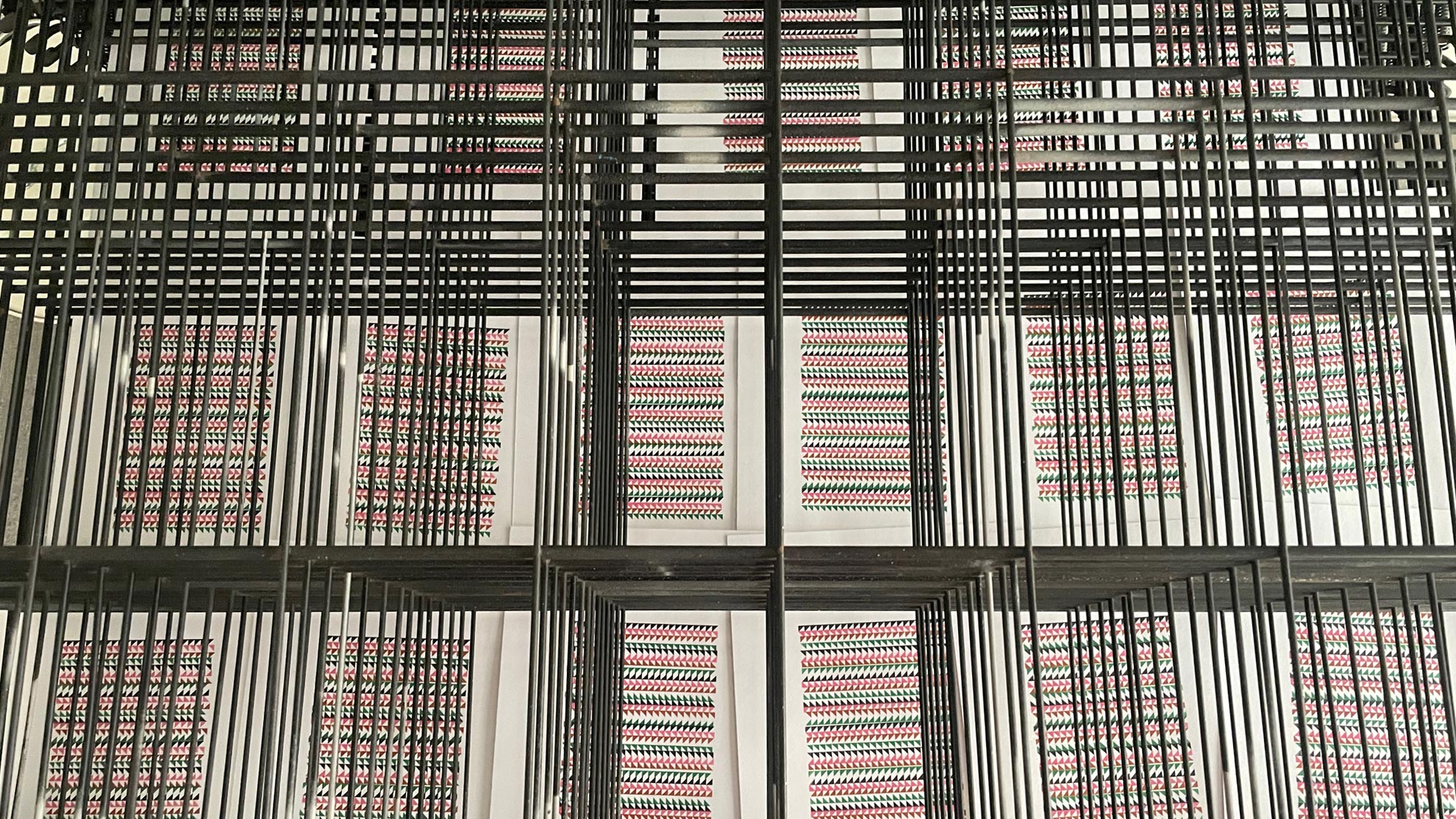 Looking through drying rack at prints drying